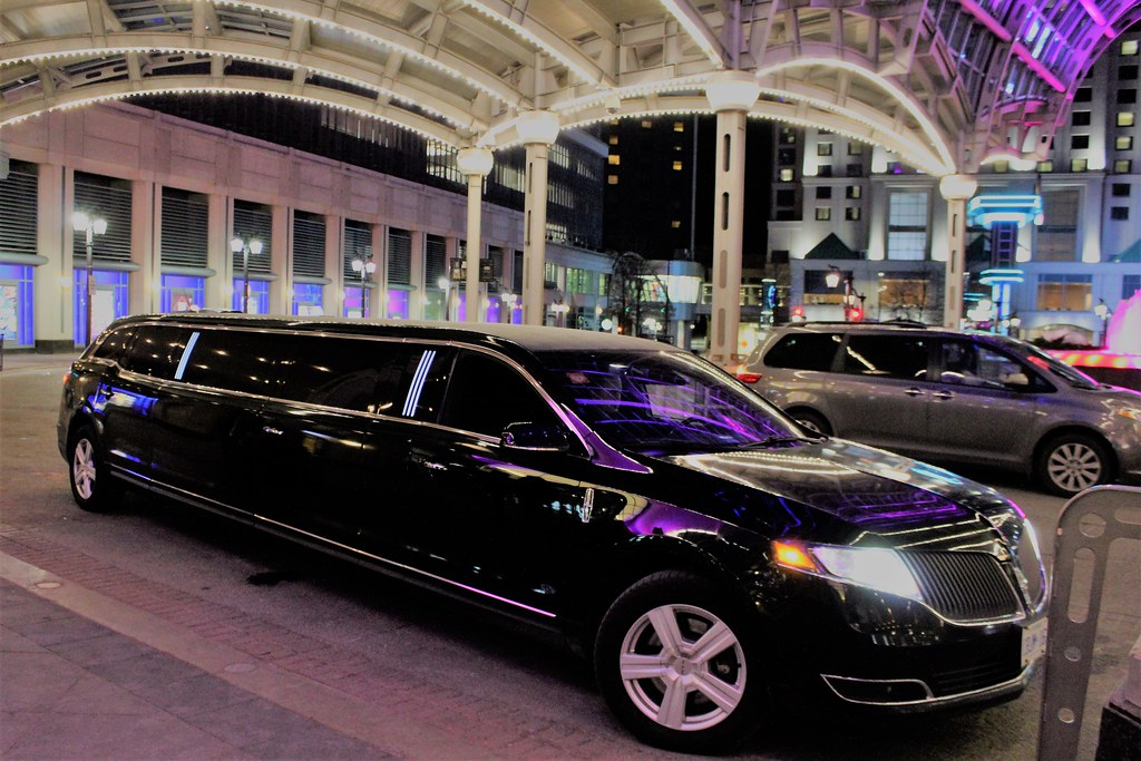 chicago-black-car-service-background 2 A sleek, luxury black car driving through downtown Chicago, representing premium private transportation.